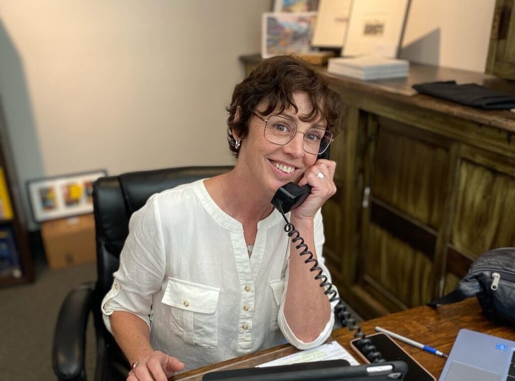 Smiling business and loans advisor on the phone at Elgin Business Resource Centre in St. Thomas, Ontario